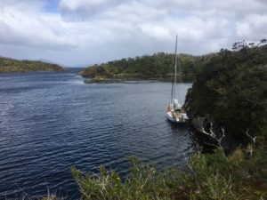 yacht at anchor in a sheltered bay waiting for a window to sail the Magellan strait