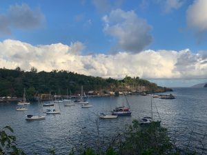 boats at anchor behind a breakwater in autona french polynesia