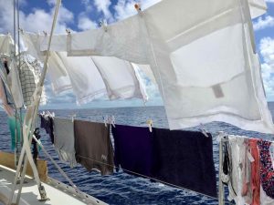 lines of washing hanging along the guardrails and rigging of the boat