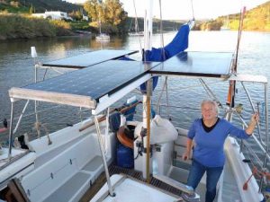 Women in cockpit of yacht showing solar panels