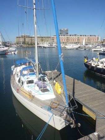 Yacht tied up to a marina pontoon.