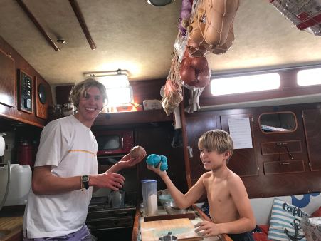 Two boys making bread.